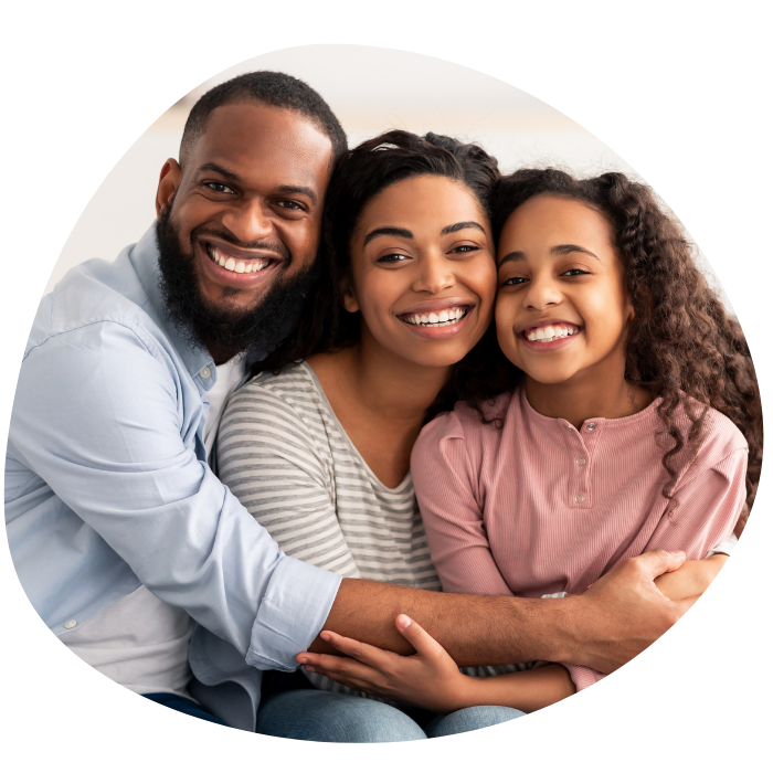 Family hugging daughter smiling Parents hugging daughter.